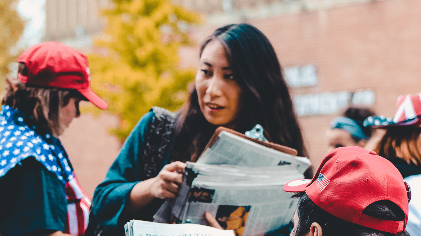 Woman carrying newspaper